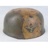 A German WWII Fallschirmjager helmet with leather lining.