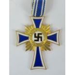 A Nazi German, Mothers' cross (4.2cm long)with blue and white ribbon, inscribed verso "16.