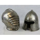 Two reproduction Medieval helmets.