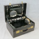 A superb gentleman's black leather vanity case stamped Mappin & Webb upon opening to reveal a full