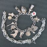 A silver charm bracelet with HM silver heart padlock clasp, Welsh themed charms (leek, dragon,