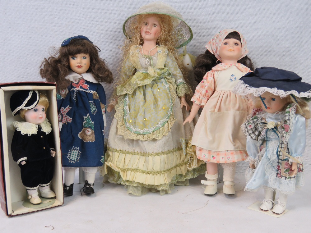 Five late 20th century dolls, all with bisque heads; smallest 26cm high largest 40cm high.