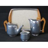 A c1960's magnailium Piquot Ware tea service comprising; tea pot, hot water pot,