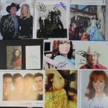 A collection of nine mostly 10x8" photos, signed by Country stars Garth Brooks, Tricia Yearwood,