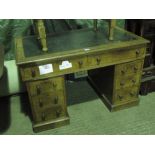 A Victorian oak pedestal kneehole desk having twin frieze drawers and three drawers under to each