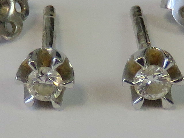 A pair of 18ct white gold and diamond stud earrings, 0.