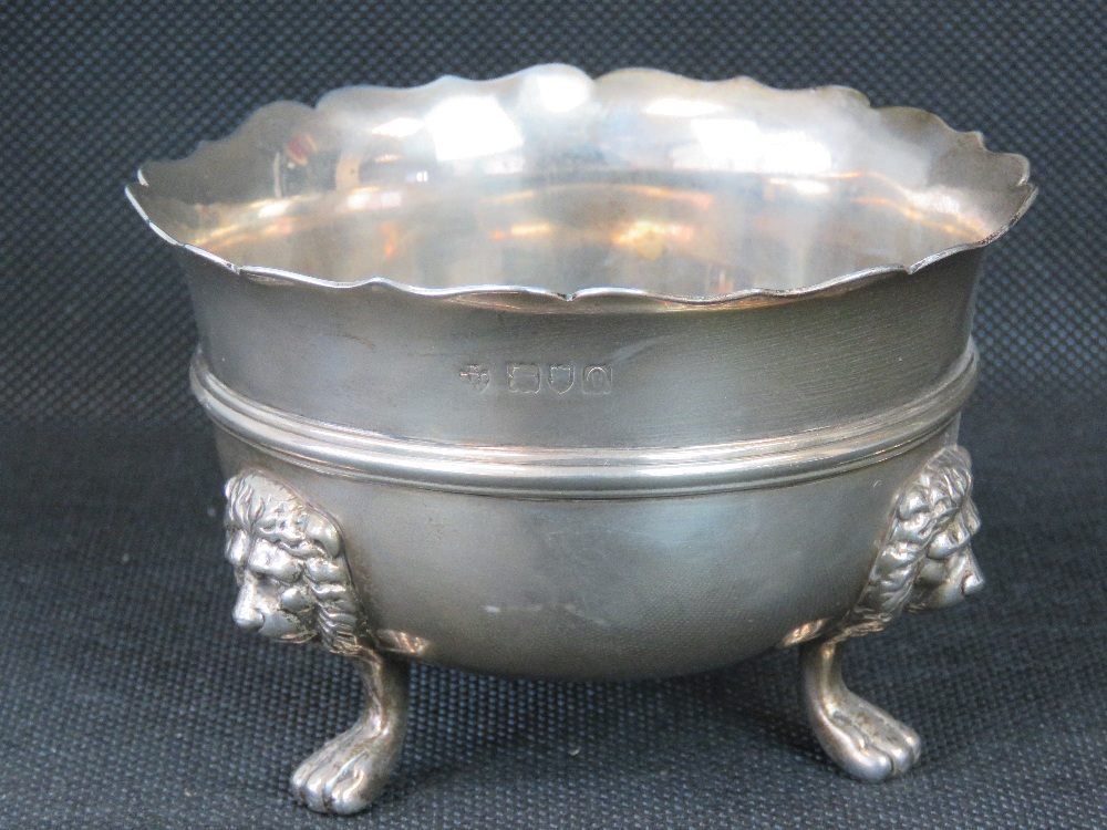 A heavy HM silver sugar bowl raised over three lions head and paw legs, London 1909, 7.41ozt.