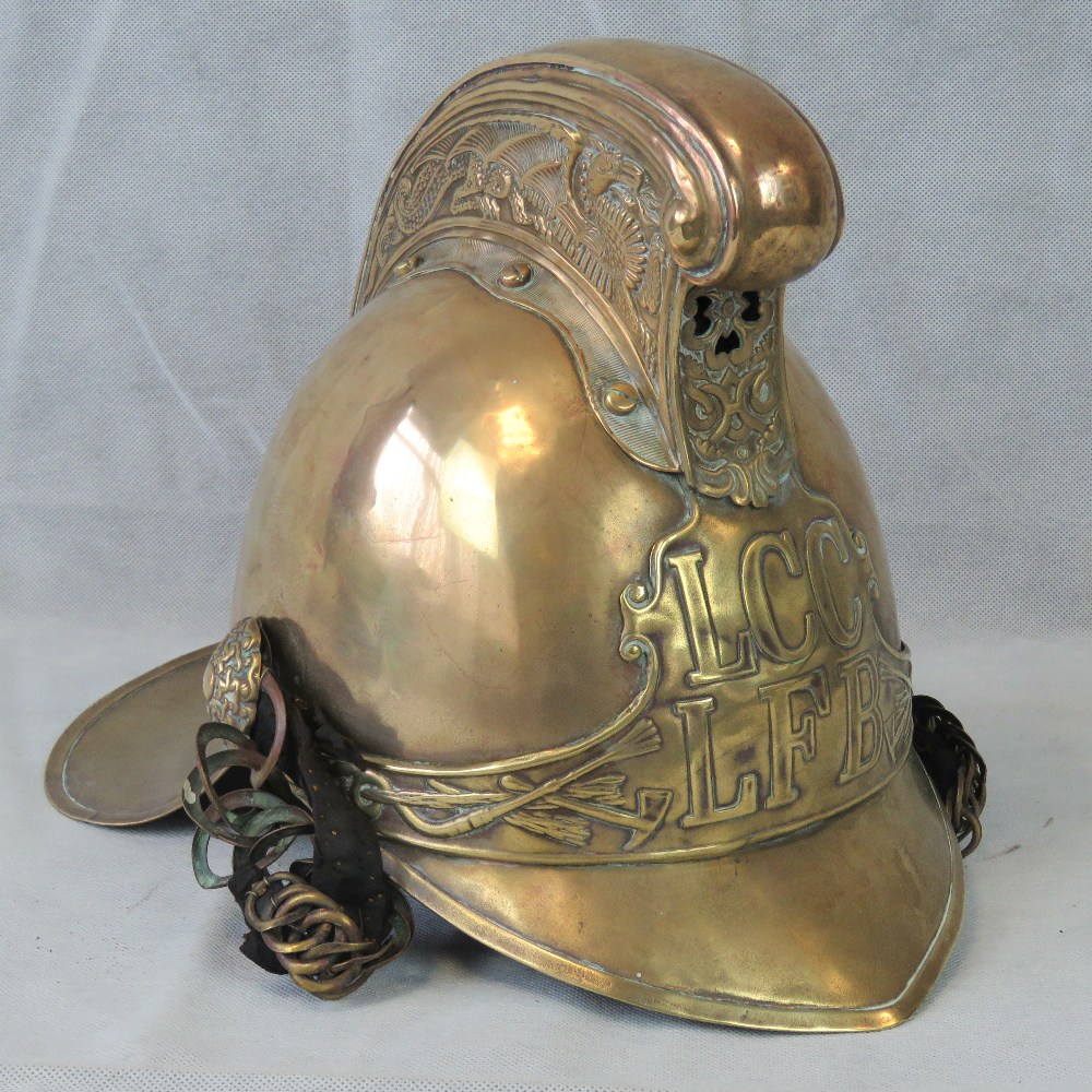 A vintage London Fire Brigade brass firemans helmet, marked LCC LFB upon,