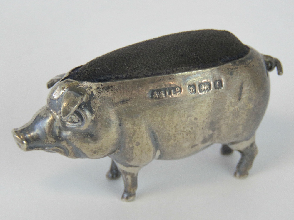 An Edwardian HM silver pin cushion in the form of a pig by Adie and Lovekin Ltd, Birmingham 1905, 4.