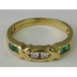 An 18ct gold diamond and emerald ring, pair of round brilliant cut diamonds approx 0.