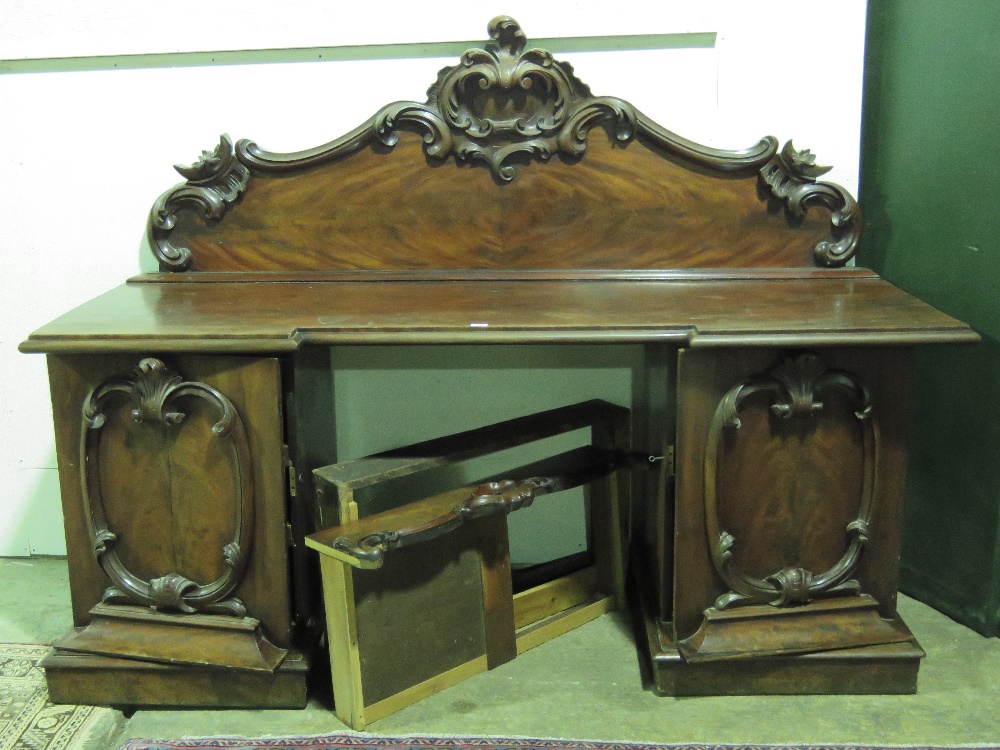 A large and impressive Victorian sideboard, carved and shaped back,