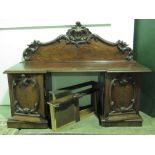 A large and impressive Victorian sideboard, carved and shaped back,