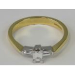 An 18ct gold three stone diamond ring, central emerald cut diamond approx 0.