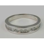 A 9ct white gold and diamond half eternity ring,