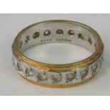 An 18ct white and yellow gold eternity ring set with white stones, size J-K, 4.