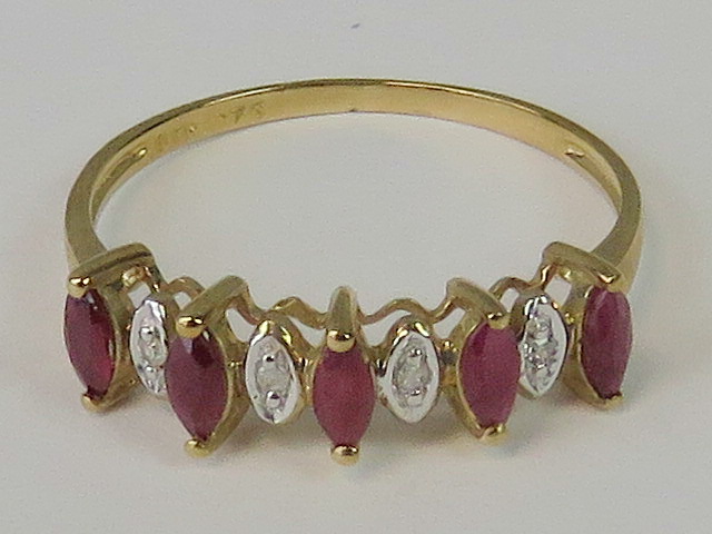 A 9ct gold ruby and diamond ring, five marquise cut rubies,
