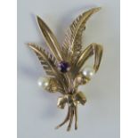 A 9ct gold floral brooch set with amethyst and two pearls, 4.