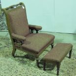 A late Victorian low fireside chair with matching footstool.