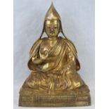 A superb and heavy Buddhist seated figurine in gilt brass.