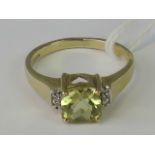 A 9ct gold quartz and diamond ring, square cushion cut quartz of yellow green hue approx 1.
