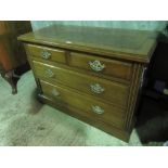 An Edwardian chest of two short over two long drawers all with matching gilt brass handles.