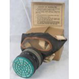 A vintage medium sized gas mask with fitted cardboard container.