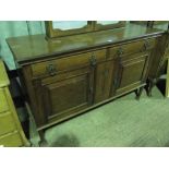 A 1930s oak sideboard having two drawers and two doors. 154cm wide.