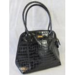 Osprey London; a black crocodile effect ladies handbag, 39cm wide.