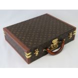 Louis Vuitton; a vintage briefcase having single handle and brass fittings.