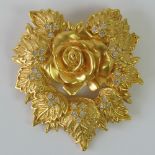 An Elizabeth Taylor for Avon brooch, rose and foliage design set with white stones, 6 x 6.5cm.