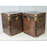A pair of leather covered Army and Navy travelling trunks having brass locks, studs and bracing,