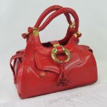Jimmy Choo: a red leather handbag having two loop handles and gilded fittings stamped Jimmy Choo.