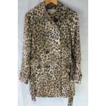 Michael Kors; a leopard print trench coat, size M, 70% cotton, complete with original belt,