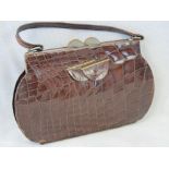 A small vintage brown leather crocodile skin handbag having nickel plated fittings,
