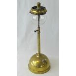 A vintage brass gas lamp with small glass globe, standing 50cm high.