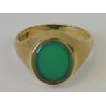 A 9ct gold signet ring with uncarved green agate oval plaque, hallmarked 375, size V, 6.