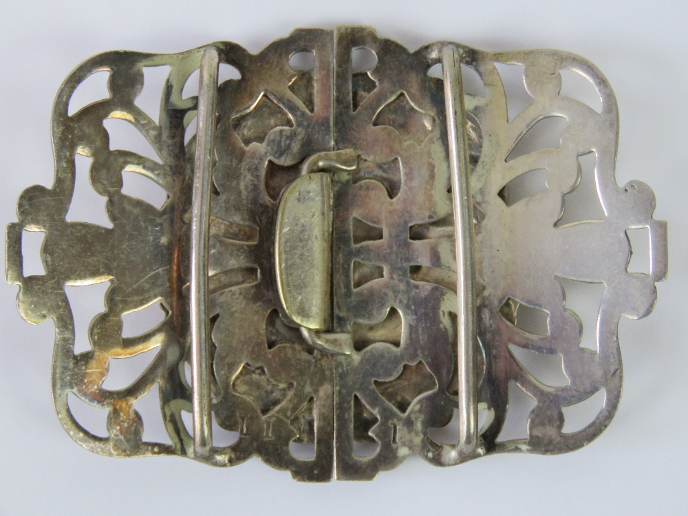 A large white metal belt buckle, central circular plaque with repoussé depiction of cherubs, - Image 2 of 2