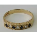A 9ct gold sapphire and diamond ring, four sapphires separated by three diamonds, hallmarked 375,