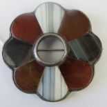 A pietra dura style Scottish hardstone brooch, white metal mounting, 5.5cm dia.