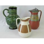 A large and ornate Continental green glazed jug,