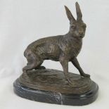 A cast brass and bronzed figurine of a leveret on marble base. Unsigned. 19cm x 19cm.