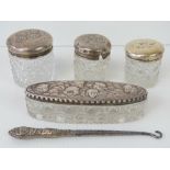 Four HM silver topped cut glass dressing table pots, each with repoussé cherub design,