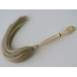 An antique ivory handled Egyptian-themed fly whisk. Handle 18cm long.