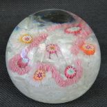 A millefiori floral hemispherical glass paperweight. 7.5cm diameter.