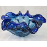 A heavy glass blue bubbled handkerchief bowl by Whitefriars. 19cm diameter.