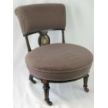 A Victorian circular occasional chair having ebonised and reeded decoration throughout,