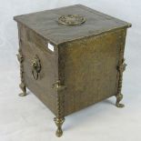 An early 20th century log bin with brass sheet covering and fittings and cast iron metal liner;