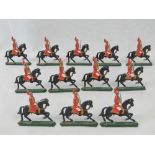 Twelve vintage hand painted lead figures of British mounted cavalry in ceremonial uniform.