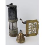 A vintage 'Davey' type miners lamp numbered '71' spin together with a pierced brass fireside trivet