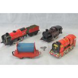 Three vintage style contemporary tin plate clockwork steam type locomotives, and two trailers.